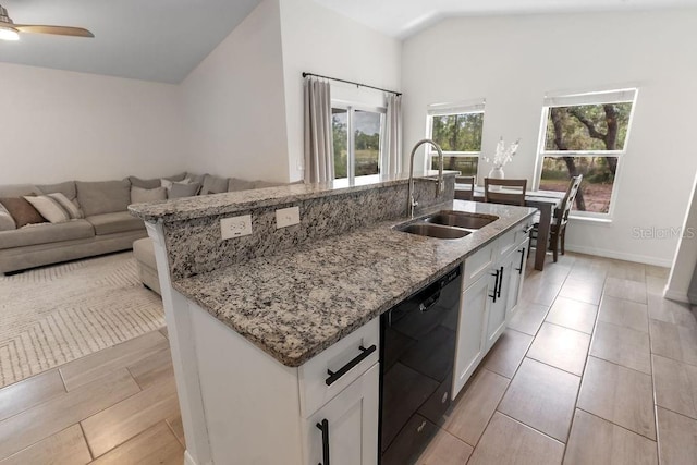1092 Gage Ave, Deltona, FL 32738 - kitchen featuring dishwasher, a sink, a kitchen island with sink, light stone countertops, and white cabinetry