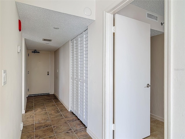 1 Oceans W Blvd Unit 2A1, Daytona Beach, FL 32118 - corridor featuring a textured ceiling and baseboards