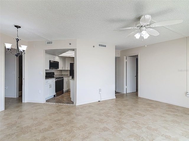 1 Oceans W Blvd Unit 2A1, Daytona Beach, FL 32118 - unfurnished living room with a ceiling fan, a chandelier, a textured ceiling, baseboards, and light tile patterned floors