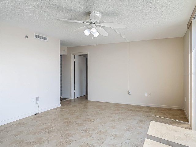 1 Oceans W Blvd Unit 2A1, Daytona Beach, FL 32118 - spare room with a ceiling fan, a textured ceiling, and baseboards