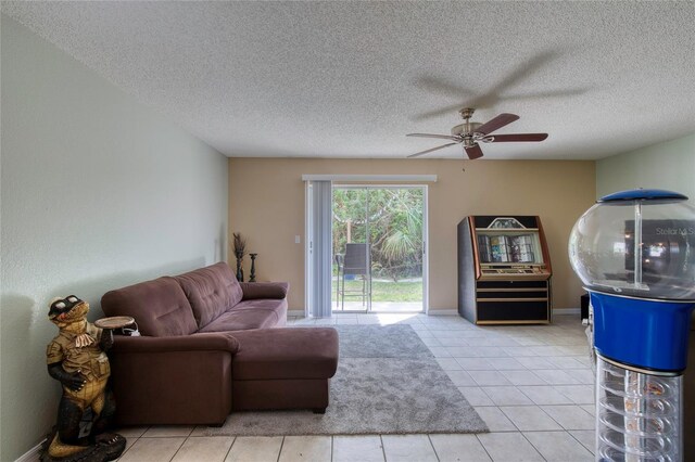 721 Laurel Bay Cir, New Smyrna Beach, FL 32169 - living room with ceiling fan, a textured ceiling, and light tile patterned floors