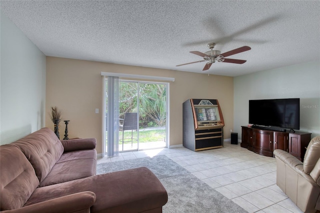 721 Laurel Bay Cir, New Smyrna Beach, FL 32169 - living room featuring ceiling fan, light tile patterned flooring, a textured ceiling, and baseboards