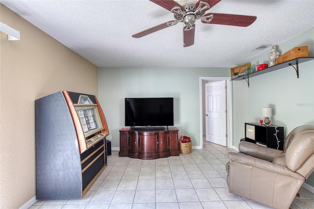 721 Laurel Bay Cir, New Smyrna Beach, FL 32169 - living area featuring a textured ceiling, a ceiling fan, light tile patterned flooring, and baseboards