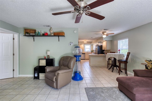 721 Laurel Bay Cir, New Smyrna Beach, FL 32169 - living room with plenty of natural light, a textured ceiling, light tile patterned flooring, and a ceiling fan