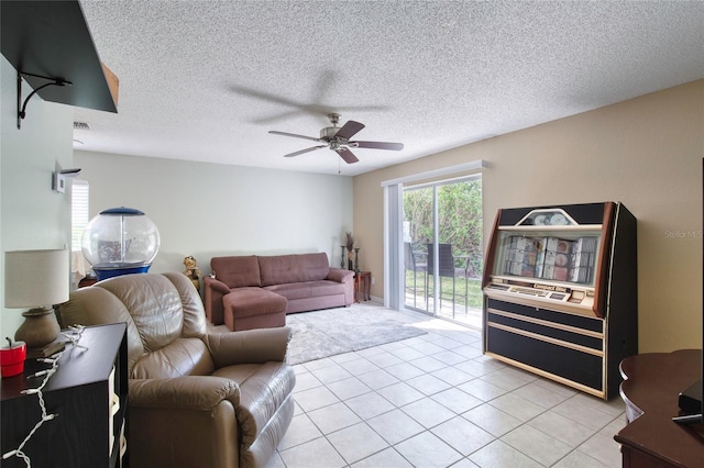 721 Laurel Bay Cir, New Smyrna Beach, FL 32169 - living room with ceiling fan, light tile patterned floors, and a textured ceiling