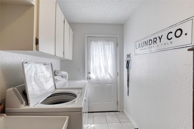 721 Laurel Bay Cir, New Smyrna Beach, FL 32169 - washroom with washer and dryer, cabinet space, light tile patterned floors, a textured ceiling, and baseboards