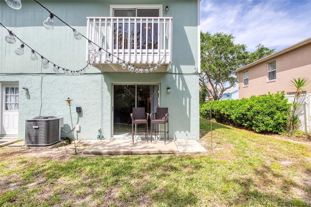 721 Laurel Bay Cir, New Smyrna Beach, FL 32169 - rear view of property featuring cooling unit, a lawn, a patio, a balcony, and stucco siding