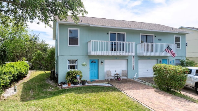 721 Laurel Bay Cir, New Smyrna Beach, FL 32169 - multi unit property featuring decorative driveway, a front lawn, a balcony, and a garage