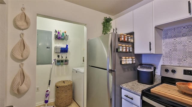 940 Village Trl Unit 8-205, Port Orange, FL 32127 - kitchen featuring appliances with stainless steel finishes, electric panel, washer / dryer, white cabinets, and decorative backsplash
