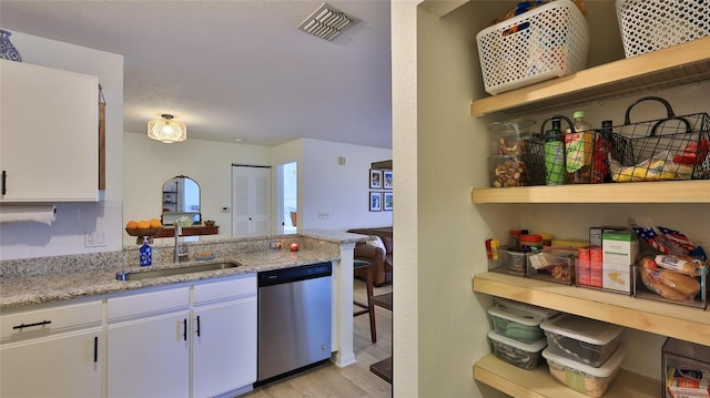 940 Village Trl Unit 8-205, Port Orange, FL 32127 - kitchen featuring stainless steel dishwasher, open shelves, white cabinetry, and light wood finished floors