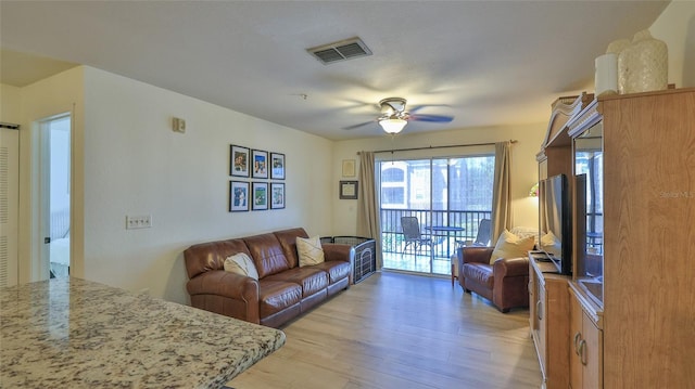 940 Village Trl Unit 8-205, Port Orange, FL 32127 - living room with light wood finished floors and ceiling fan