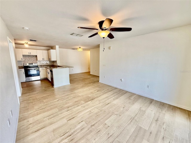 940 Village Trl Unit 8-205, Port Orange, FL 32127 - kitchen featuring stainless steel electric stove, open floor plan, a ceiling fan, white cabinets, and backsplash