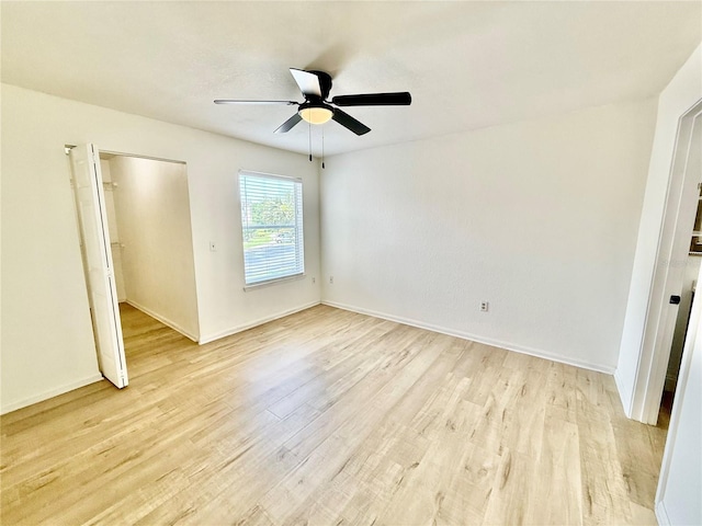 940 Village Trl Unit 8-205, Port Orange, FL 32127 - unfurnished bedroom featuring light wood-type flooring, a ceiling fan, and a closet