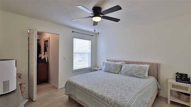 940 Village Trl Unit 8-205, Port Orange, FL 32127 - bedroom featuring light wood-style floors, ceiling fan, and a spacious closet