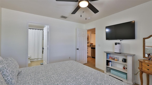 940 Village Trl Unit 8-205, Port Orange, FL 32127 - bedroom with light wood-style flooring, connected bathroom, and a ceiling fan