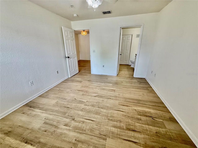 940 Village Trl Unit 8-205, Port Orange, FL 32127 - unfurnished bedroom with wood finished floors and ensuite bath