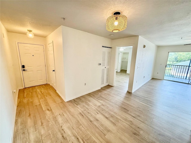 940 Village Trl Unit 8-205, Port Orange, FL 32127 - unfurnished room featuring light wood finished floors, fire sprinkler in ceiling, a textured ceiling, and ceiling fan