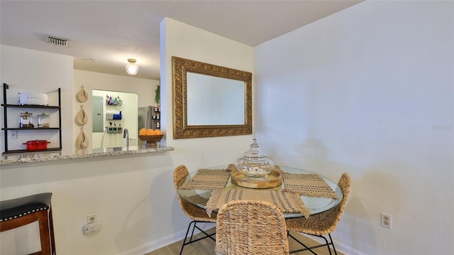 940 Village Trl Unit 8-205, Port Orange, FL 32127 - dining area featuring baseboards and wood finished floors