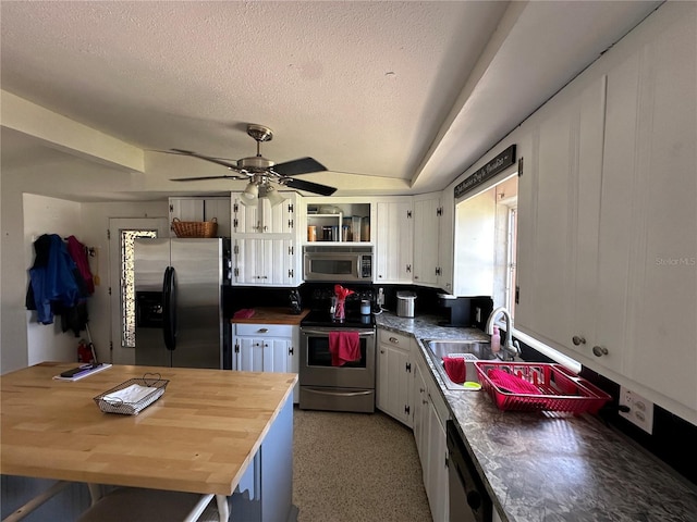 29146 Tamayo Dr, Punta Gorda, FL 33982 - kitchen featuring appliances with stainless steel finishes, white cabinetry, a sink, wooden counters, and a textured ceiling