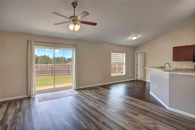 6 Laurel Pass Ct, Ocala, FL 34480 - unfurnished living room with dark wood finished floors, ceiling fan, baseboards, lofted ceiling, and a sink