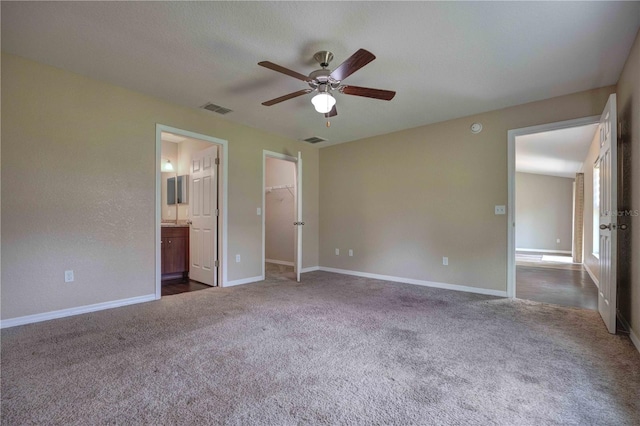 6 Laurel Pass Ct, Ocala, FL 34480 - unfurnished bedroom with dark colored carpet, a walk in closet, baseboards, ensuite bathroom, and a ceiling fan