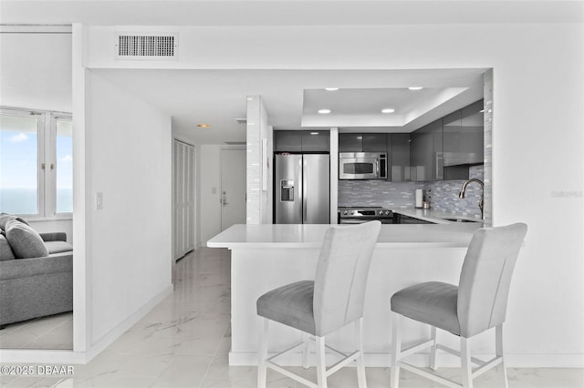 3047 S Atlantic Ave Unit 1805, Daytona Beach, FL 32118 - kitchen with appliances with stainless steel finishes, light marble finish flooring, modern cabinets, a kitchen breakfast bar, and recessed lighting