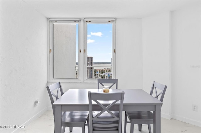 3047 S Atlantic Ave Unit 1805, Daytona Beach, FL 32118 - dining room with marble look tiles and baseboards