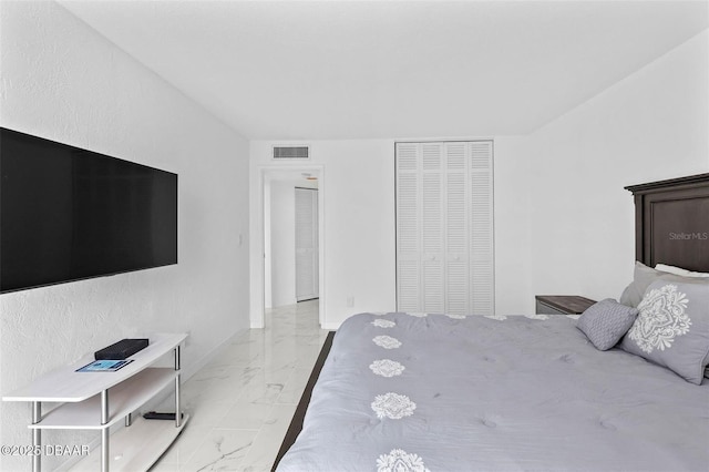 3047 S Atlantic Ave Unit 1805, Daytona Beach, FL 32118 - bedroom featuring light marble finish flooring, a closet, and baseboards