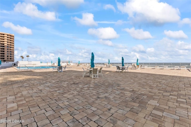 3047 S Atlantic Ave Unit 1805, Daytona Beach, FL 32118 - view of property's community with a pool, a patio, and a water view