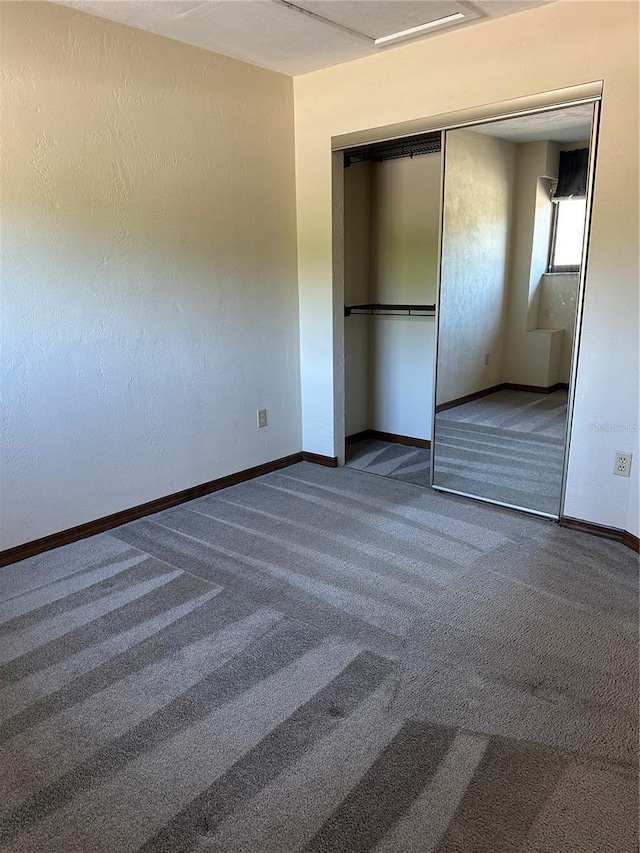 96 Old Barn Trl, Ormond Beach, FL 32174 - unfurnished bedroom with carpet floors, baseboards, and a closet