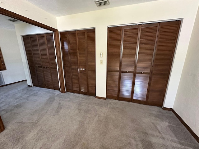96 Old Barn Trl, Ormond Beach, FL 32174 - unfurnished bedroom featuring carpet, two closets, and baseboards