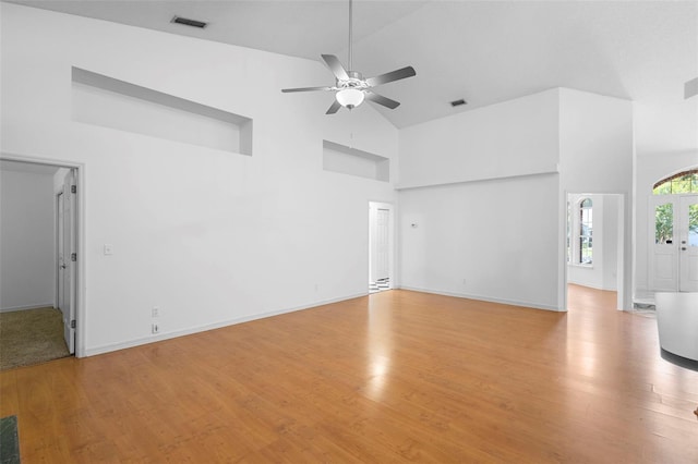 802 Royal Oak Ct, Deland, FL 32724 - unfurnished living room with high vaulted ceiling, a ceiling fan, light wood-type flooring, and baseboards