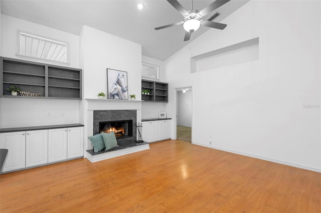 802 Royal Oak Ct, Deland, FL 32724 - unfurnished living room with a fireplace, high vaulted ceiling, light wood-style flooring, ceiling fan, and baseboards