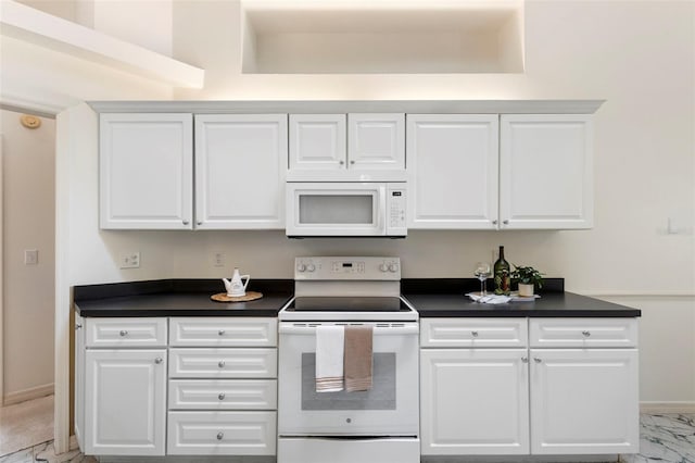 802 Royal Oak Ct, Deland, FL 32724 - kitchen featuring white appliances, dark countertops, light marble finish floors, white cabinetry, and baseboards
