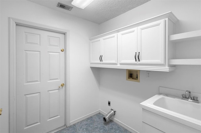 802 Royal Oak Ct, Deland, FL 32724 - washroom with cabinet space, washer hookup, hookup for an electric dryer, a textured ceiling, and baseboards