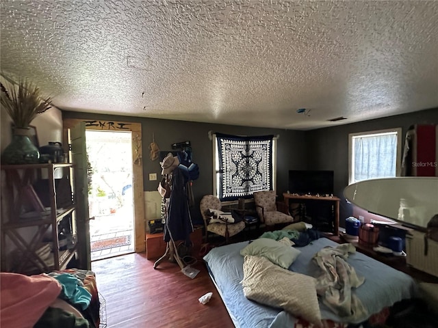 43721 State Road 19, Altoona, FL 32702 - bedroom with a textured ceiling, multiple windows, wood finished floors, and access to outside