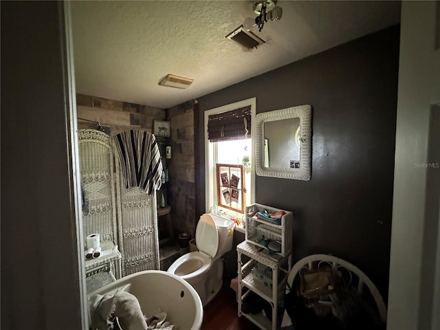 43721 State Road 19, Altoona, FL 32702 - bathroom featuring a textured ceiling, toilet, and a bidet