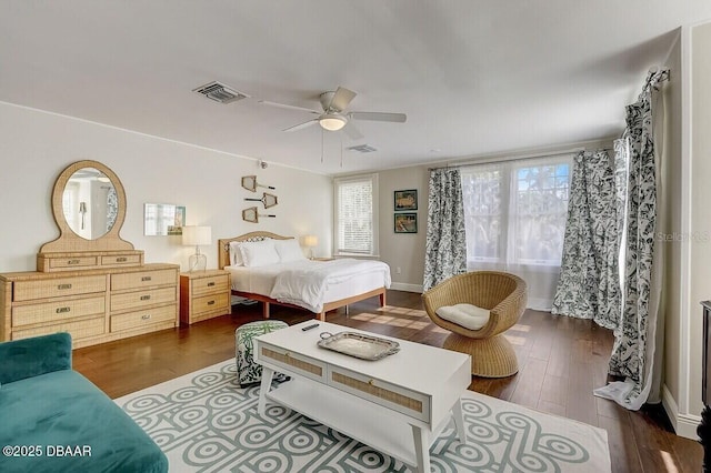 404 S Ridgewood Ave, Daytona Beach, FL 32114 - bedroom with dark wood-type flooring, ceiling fan, and baseboards