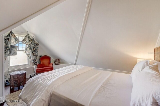 404 S Ridgewood Ave, Daytona Beach, FL 32114 - bedroom with vaulted ceiling and baseboards