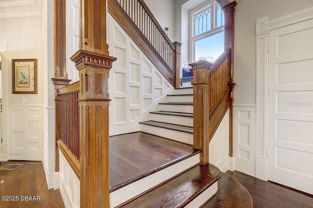 404 S Ridgewood Ave, Daytona Beach, FL 32114 - stairway with a decorative wall, wainscoting, and wood finished floors