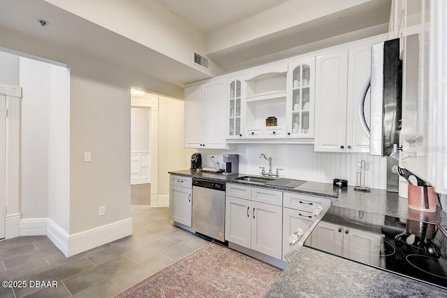 404 S Ridgewood Ave, Daytona Beach, FL 32114 - kitchen with appliances with stainless steel finishes, a sink, open shelves, and white cabinets