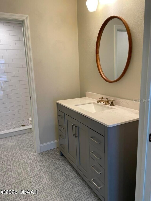 404 S Ridgewood Ave, Daytona Beach, FL 32114 - bathroom with vanity, a shower stall, and baseboards