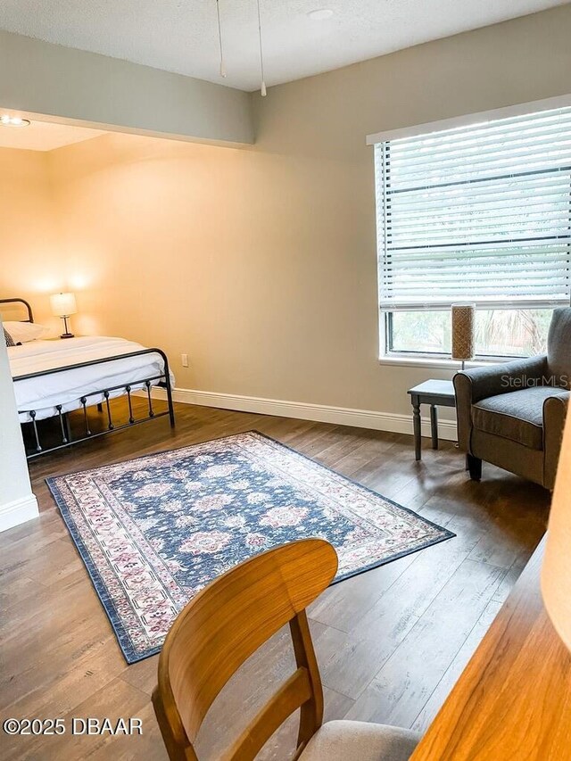 404 S Ridgewood Ave, Daytona Beach, FL 32114 - bedroom with baseboards and wood finished floors