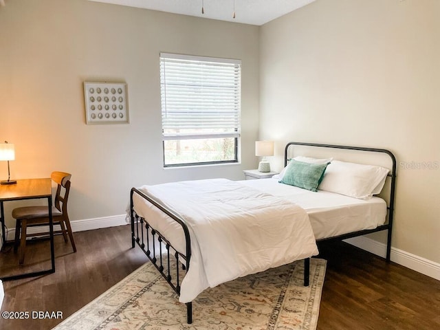 404 S Ridgewood Ave, Daytona Beach, FL 32114 - bedroom with baseboards and wood finished floors