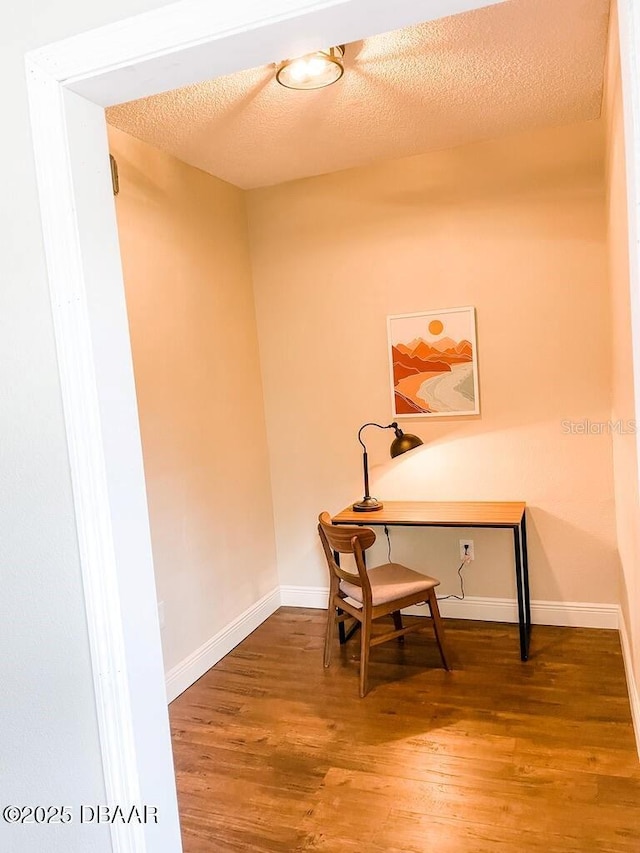 404 S Ridgewood Ave, Daytona Beach, FL 32114 - office featuring wood finished floors, a textured ceiling, and baseboards