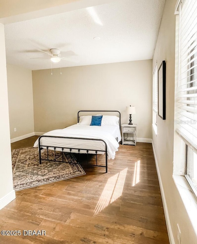 404 S Ridgewood Ave, Daytona Beach, FL 32114 - bedroom featuring multiple windows, wood finished floors, and baseboards
