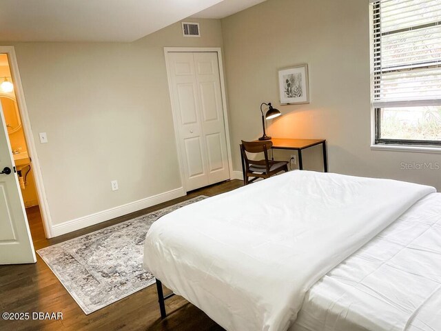 404 S Ridgewood Ave, Daytona Beach, FL 32114 - bedroom with wood finished floors, baseboards, and a closet