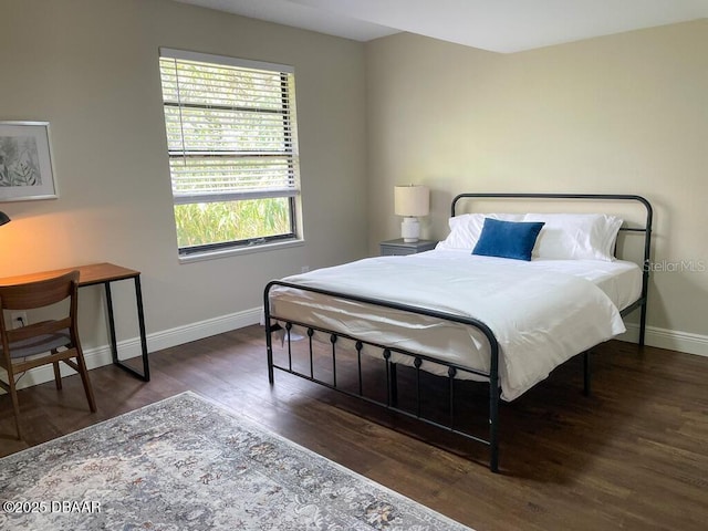 404 S Ridgewood Ave, Daytona Beach, FL 32114 - bedroom with baseboards and wood finished floors