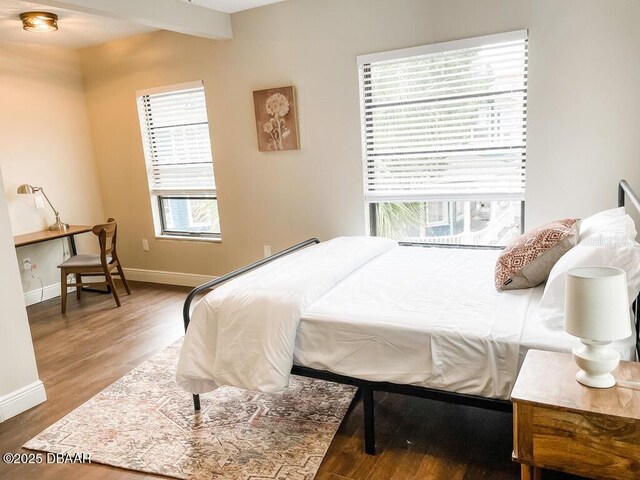 404 S Ridgewood Ave, Daytona Beach, FL 32114 - bedroom with multiple windows, wood finished floors, and baseboards