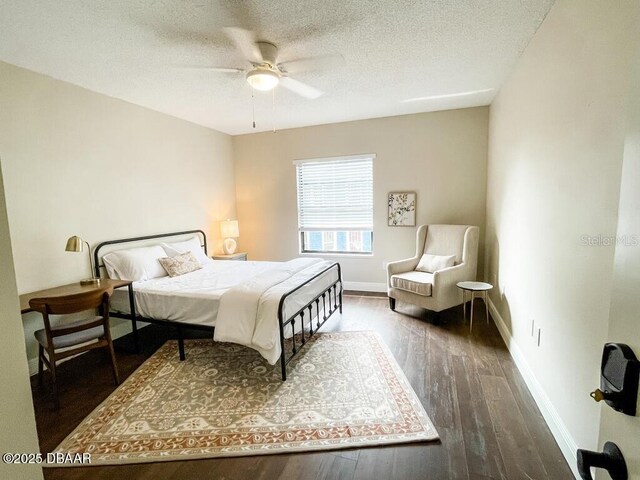 404 S Ridgewood Ave, Daytona Beach, FL 32114 - bedroom with wood finished floors, a textured ceiling, baseboards, and a ceiling fan